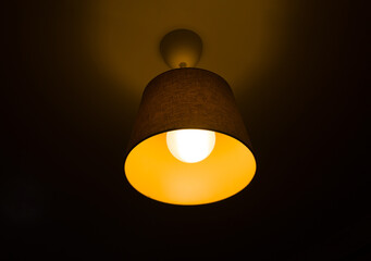 Glowing ceiling lamp at night