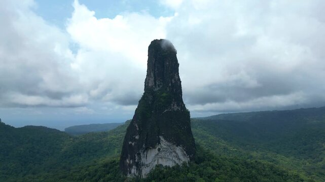 Flying over the green forest of S&atilde;o Tom&eacute; e Principe at a high altitude in a circular pattern towards Pico Cao Grande.