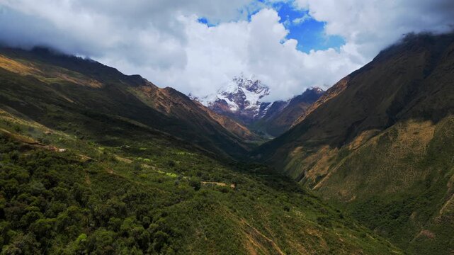 Mount Humantay Salkantay trail road Peru aerial drone high altitude Peruvian Andes snow capped glacier peaks Laguna Humantay Lake dry season sunny blue sky morning Anta province forward pan up motion