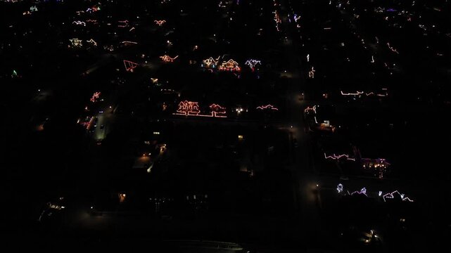 Flying over a neighborhood at night looking at all the Christmas lights lit up on the houses