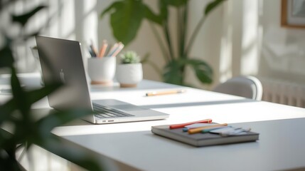 Modern workspace with laptop and stationery