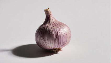 Single bulb of garlic with purple tinges on a white background.