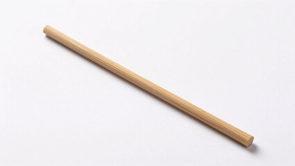 Obraz premium A single, smooth wooden dowel lies diagonally across a clean white background, showcasing its polished cylindrical form and subtle wood grain texture.