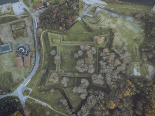 Aerial view of the formidable Fortaleza de Goian, a star-shaped fortress embraced by earthworks and lush greenery, standing as a testament to history, Goian, Pontevedra, Spain.
