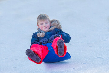 Boy Races Down an Icy Hill on a Plastic Shovel Sled