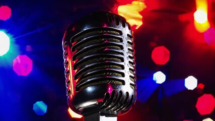 Live performance highlights with a microphone on stage during a lively event at night