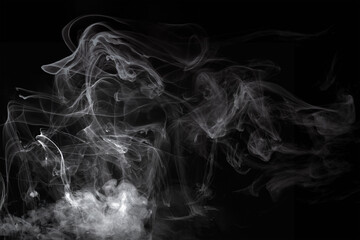 Wisps of white smoke isolated on a black background with space for text