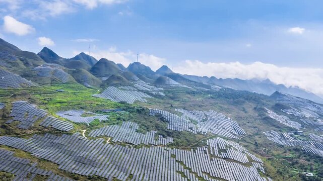aerial time-lapse of a vast solar power station on rocky hills in Guizhou, China, blending renewable energy with stone desertification mountainous landscape under a clear blue sky.