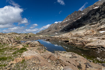 Scenic mountain landscape with an alpine lake in the Grandes Rousses massif, French Alps.