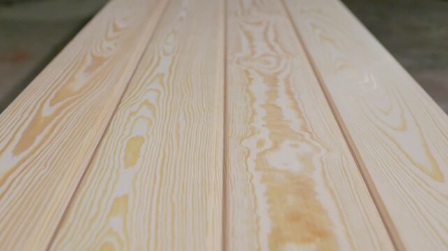 Detailed view of pine wood planks showcasing natural grain patterns and smooth finish, arranged in parallel with visible copy space