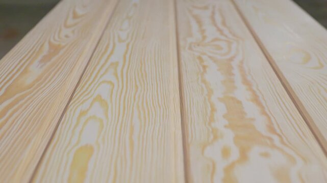 Detailed view of pine wood planks showcasing natural grain patterns and smooth finish, arranged in parallel with visible copy space