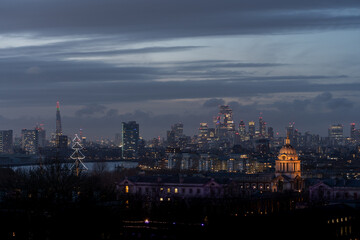 City skyline at dusk with illuminated tree