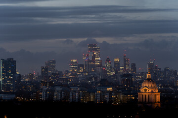 Evening city skyline with illuminated buildings
