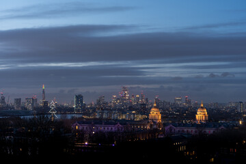 City skyline at dusk with glowing lights