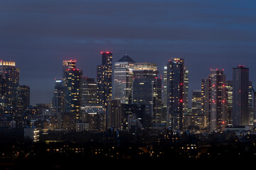 Nighttime cityscape with illuminated skyscrapers