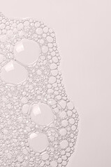 The texture of the foam of shower gel or soap suds or shaving foam. Macrophotography. Copy space