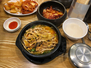 Korean Beef Offal Soup Naejangtang Served Hot in a Stone Pot with Traditional Side Dishes