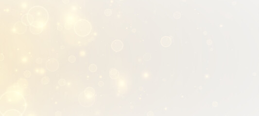 Golden glittering background. Shiny dust, bokeh effect. Magic falling golden lights and stars. © FlammaChe