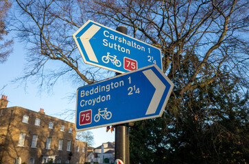 Blue road signs under clear sky