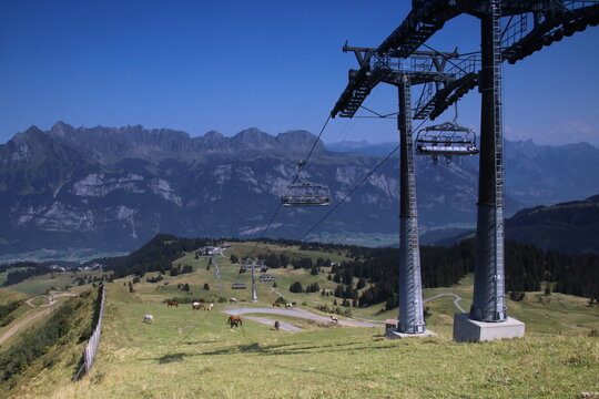 Ski lift towers in alpine mountain landscape during summer under clear blue sky