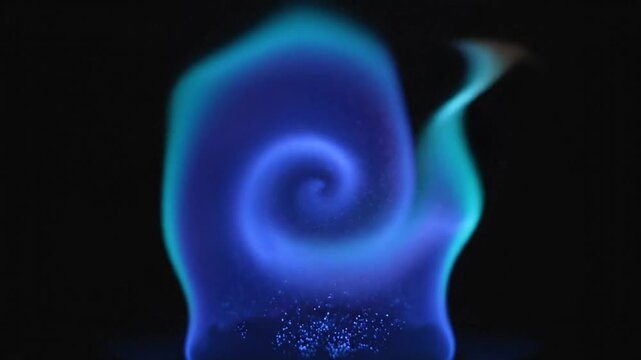 Mesmerizing close-up of a blue and green flame spiral swirling dynamically against a black background