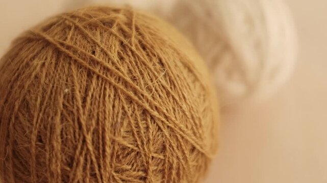 Wool yarn thread for knitting and crocheting. Warm clothes knitting hobby and crafts, slow living concept, textile industry. Closeup slow motion aesthetic video.