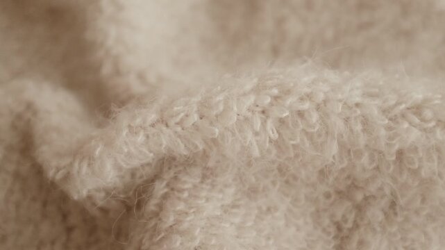 Closeup aesthetic video of hands touching soft wool sweater. Ivory fluffy knitted sweater for cold winter. Appreciating pleasant texture of high quality clothes. Soft and cosy clothes. 