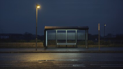 A lonely bus stop under the night lights, invoking a sense of quiet solitude and anticipation in the tranquil twilight.