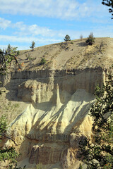 View of an eroded gravel hoodoo standing below a layer of columnar basalt, Yellowstone National Park, Wyoming  USA
