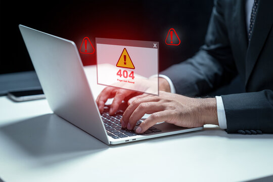 Businessman types on a laptop displaying a 404 error message. This image represents technical difficulties, website problems, and the frustration of encountering errors while working online