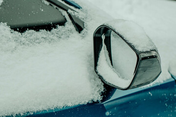 Brushing Snow Off a Car Windshield in Winter