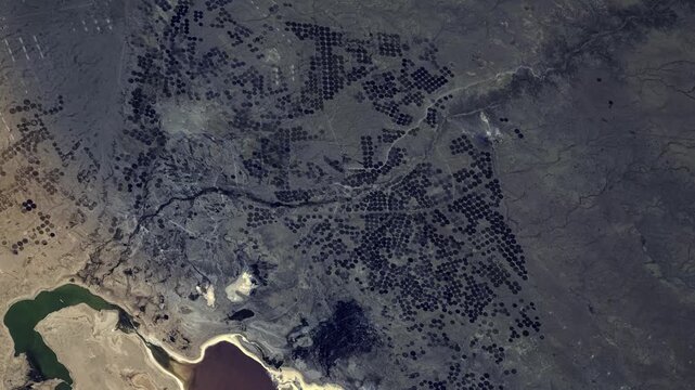 Satellite view of Milh Razazah Lake, Iraq, sunrise time lapse over center pivot circular agricultural landscape based on NASA imagery