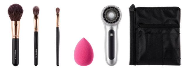 Photograph of four makeup brushes, one pink makeup sponge, silver hairdryer, and black textured zippered pouch on.