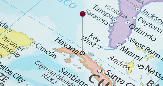 A zoom out of a red pin into havana city of cuba political map