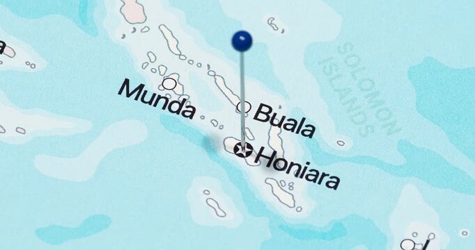A zoom out of a blue pin into honiara city of solomon islands political map