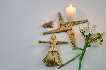 St brigid's cross, doll, candle, snowdrops celebrating imbolc