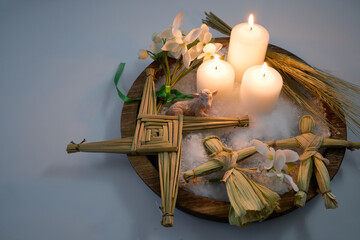 Imbolc brigid cross and figurines celebrating celtic spring