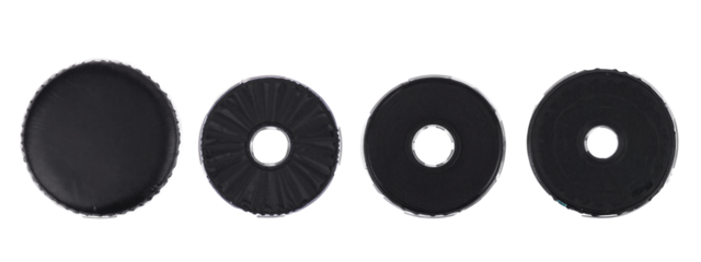 Four black circular discs with different textures, arranged horizontally . From left to right: smooth, textured with radial lines, with a central hole, and brushed with a central hole.