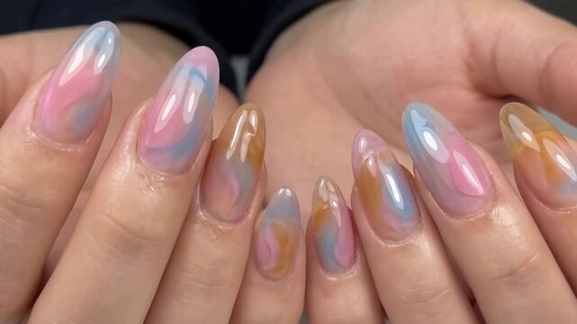 Close-up shot of elegant fingernails with a stunning swirl design. The artistic nails showcase a beautiful blend of colors and intricate patterns. 