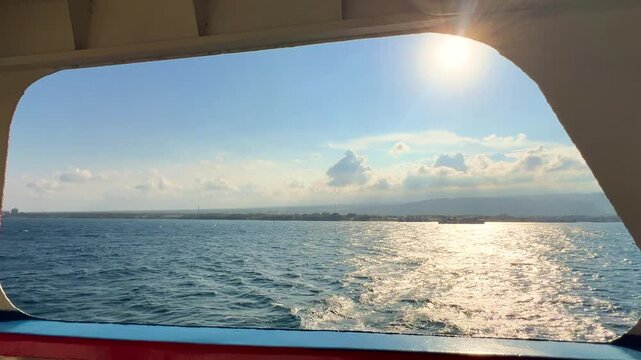 Bali, Indonesia - August 27, 2025: Car and passenger ferries cross the Bali Strait from Gilimanuk Harbor to Ketapang Harbor. View of the strait from the ferry deck. 4К