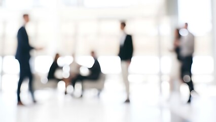 Abstract blurred office lobby scene with silhouettes of business professionals in conversation (soft focus, high-key lighting)