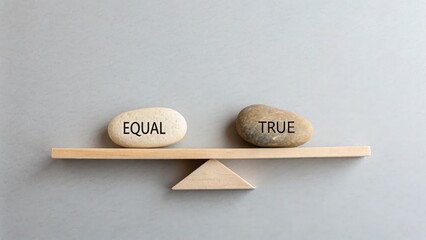 Stones labeled Equal and True weighing on a wooden balance beam
