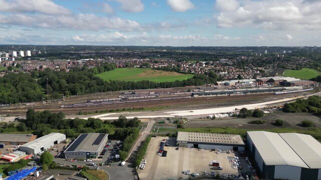 Aerial drone footage flying towards Neville Hill railway depot in Leeds, England. Rail lines, train maintenance facilities illustrating rail operations, transport infrastructure, and logistics.