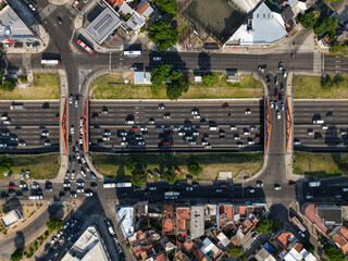 A busy intersection with a lot of traffic and a bridge over a highway. Aerial View © SobrevolandPatagonia