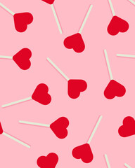 Seamless pattern of heart-shaped lollipops on a pink background