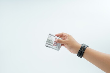 Hand holding US dollar banknote on white background representing payment, cash transaction, financial exchange, income, salary, and money concept with copy space.