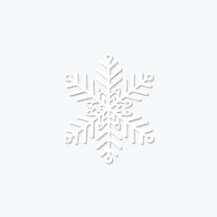 A white paper snowflake with shadow effect against a plain white background