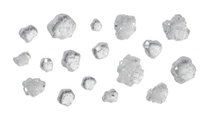 Macro view of translucent salt crystals scattered on a black background close-up