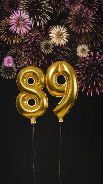 Gold balloon number 89 with fireworks in the background. Festive scene for birthday or anniversary party