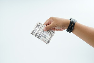 Hand holding US dollar banknote on white background representing payment, cash transaction, financial exchange, income, salary, and money concept with copy space.